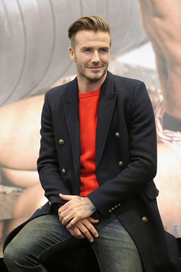 David-Beckham-wears-navy-Saint-Laurent-double-breasted-gold-buttoned-officer-coat-and-Alexander-McQueen-Red-Cashmere-Crew-Neck-Sweater-at-HM-Superbowl-Event-1