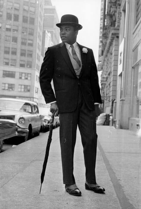 26th May 1963: American Heavyweight boxer, Cassius Clay (later Muhammad Ali), in New York, dressed like a city gent in a suit and a bowler hat and carrying an umbrella. (Photo by Express/Express/Getty Images)